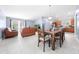 Open-concept living and dining area with tile flooring, comfortable furniture, and ample space for Gathering gatherings at 236 Miles Ct, Davenport, FL 33837