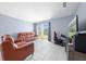 Bright living room boasts tile floors, modern furniture, and a large window with natural light at 236 Miles Ct, Davenport, FL 33837