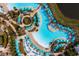 Stunning aerial view of resort-style pool with turquoise umbrellas and lush landscaping at 2923 Castaway Ln, Kissimmee, FL 34747