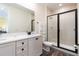 Bright bathroom featuring a double vanity with a modern black framed glass shower and neutral color palette at 2923 Castaway Ln, Kissimmee, FL 34747