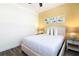 Cozy bedroom with a queen size bed, neutral bedding, and colorful fish artwork at 2923 Castaway Ln, Kissimmee, FL 34747