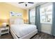 Comfortable bedroom with bright windows, neutral bedding, and colorful fish artwork at 2923 Castaway Ln, Kissimmee, FL 34747