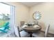 Dining area featuring a round table set for four, with an open view to the backyard and patio at 2923 Castaway Ln, Kissimmee, FL 34747