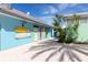 Bright blue building exterior with surfboards, adjacent to tropical landscaping at 2923 Castaway Ln, Kissimmee, FL 34747