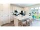 Bright kitchen featuring stainless steel appliances, white cabinets and an island with bar stool seating at 2923 Castaway Ln, Kissimmee, FL 34747