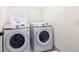 Laundry room featuring a side-by-side Samsung washer and dryer at 2923 Castaway Ln, Kissimmee, FL 34747