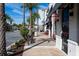 Street view of a street lined with palm trees and shops on a sunny day, complete with a bench for resting at 2923 Castaway Ln, Kissimmee, FL 34747