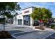 Exterior of the Bento restaurant featuring a patio with tables, and a clean exterior with palm trees around the street at 2923 Castaway Ln, Kissimmee, FL 34747
