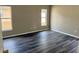Spacious bedroom with updated flooring and natural light from two windows at 307 Dalton Ct, Davenport, FL 33897