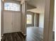 Inviting entryway with double doors and modern gray wood-look flooring at 307 Dalton Ct, Davenport, FL 33897