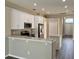 Stylish kitchen with stainless appliances, granite counters, and white cabinets at 307 Dalton Ct, Davenport, FL 33897