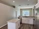 Modern kitchen with white cabinets, stainless steel appliances, and granite countertops at 307 Dalton Ct, Davenport, FL 33897
