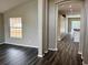 Spacious living area with gray wood-look flooring and an open archway at 307 Dalton Ct, Davenport, FL 33897