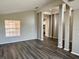 Open-concept living room featuring gray wood-look floors and ample natural light at 307 Dalton Ct, Davenport, FL 33897