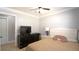 Cozy bedroom with a ceiling fan, and a large dresser with television and white trim at 3223 Dragoon Pl, Orlando, FL 32818