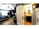Spacious living area showcasing a modern bathroom addition with stylish sliding barn door and tile flooring at 3223 Dragoon Pl, Orlando, FL 32818