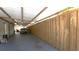 Carport with aluminum roofing covering the concrete, a privacy fence, and parking space at 3223 Dragoon Pl, Orlando, FL 32818