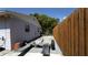 Back exterior of home with wood privacy fence and trailer and tire repair tools at 3223 Dragoon Pl, Orlando, FL 32818