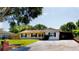 Charming single-story home featuring a well-maintained lawn and a spacious driveway, perfect for a growing Gathering at 3223 Dragoon Pl, Orlando, FL 32818