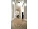 Hallway with base molding and tan tile leading to rooms with views of mounted TVs at 3223 Dragoon Pl, Orlando, FL 32818