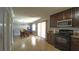 An open kitchen with dark cabinets, granite countertops, stainless steel appliances, and light tile flooring at 3223 Dragoon Pl, Orlando, FL 32818