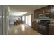 An open kitchen with dark cabinets, granite countertops, stainless steel appliances, and light tile flooring at 3223 Dragoon Pl, Orlando, FL 32818
