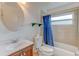 Compact bathroom features a vanity, toilet, tub with shower, and a window that provides natural light at 324 Sir Lawrence Dr, Sanford, FL 32773