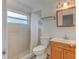 Cozy bathroom with a vanity, toilet, and shower with a white tiled wall and chrome hardware at 324 Sir Lawrence Dr, Sanford, FL 32773