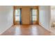 Bright bedroom with wood floors, an ensuite bathroom with shower, and large windows with blue curtains at 324 Sir Lawrence Dr, Sanford, FL 32773