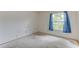 Bare bedroom with a window, cement floors, and visible wiring and nail holes needing renovation at 324 Sir Lawrence Dr, Sanford, FL 32773