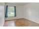 Cozy bedroom with neutral walls, window, blue curtains and unique flooring and an outlet on the wall at 324 Sir Lawrence Dr, Sanford, FL 32773