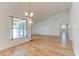 Bright living room featuring wood-look flooring, a large window, and high ceilings, creating an open and airy atmosphere at 324 Sir Lawrence Dr, Sanford, FL 32773