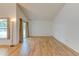 Bright living room featuring wood-look flooring, a sliding glass door, and high ceilings, creating an open and airy atmosphere at 324 Sir Lawrence Dr, Sanford, FL 32773