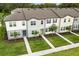 Aerial view of modern townhomes featuring well-kept lawns and inviting entryways at 3256 Merton Aly, Orlando, FL 32808