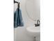 Bathroom sink with modern hardware, round mirror, and blue towel on a bar at 3256 Merton Aly, Orlando, FL 32808