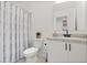 Cozy bathroom has a vanity and shower and toilet combination with a striped shower curtain at 3256 Merton Aly, Orlando, FL 32808