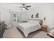 Comfortable bedroom with ceiling fan, accent wall art, window and complementary furnishings at 3256 Merton Aly, Orlando, FL 32808