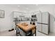 Bright, modern kitchen with white cabinets, island, and stainless steel appliances at 3256 Merton Aly, Orlando, FL 32808