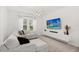 Bright living room with a large window, modern entertainment center and comfortable sectional sofa at 3256 Merton Aly, Orlando, FL 32808