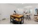 Open concept living space with a modern kitchen island, dining area, and stylish decor at 3256 Merton Aly, Orlando, FL 32808
