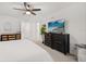 Spacious main bedroom features a ceiling fan, modern dresser, and ensuite bathroom at 3256 Merton Aly, Orlando, FL 32808