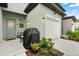 Back patio with a grill and seating area, offering an inviting outdoor space at 3256 Merton Aly, Orlando, FL 32808