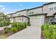Rear exterior of a townhome with a one-car garage and neat landscaping at 3256 Merton Aly, Orlando, FL 32808
