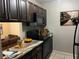 Cozy kitchen shows granite counters, dark cabinets, and black appliances at 3270 S Semoran Blvd # 15, Orlando, FL 32822