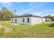 The back corner of a newly built home featuring a patio and lush green grass at 3749 Sw 131St St, Ocala, FL 34473