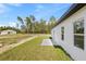 The side of a newly built home featuring a patio and lush green grass at 3749 Sw 131St St, Ocala, FL 34473
