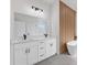 Modern bathroom features double vanity, soaking tub, wood accent wall, and matte black fixtures at 3749 Sw 131St St, Ocala, FL 34473
