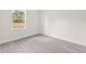 Bright bedroom features wood-look flooring, a window, and neutral paint at 3749 Sw 131St St, Ocala, FL 34473