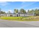 Charming corner lot single-story home with a modern design, black trim, and a two-car garage at 3749 Sw 131St St, Ocala, FL 34473