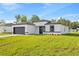 Charming single-story home featuring a modern design, black trim, and an attached two-car garage at 3749 Sw 131St St, Ocala, FL 34473